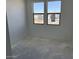 Unfinished bedroom showing two windows and a smooth cement floor at 32677 N Newby Dr, San Tan Valley, AZ 85143
