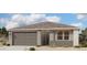 Charming single-story home featuring a tile roof, neutral color scheme, and a two-car garage at 32677 N Newby Dr, San Tan Valley, AZ 85143
