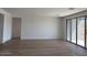 Bright, open living room with tile floors and large sliding glass doors to the outdoor area at 32677 N Newby Dr, San Tan Valley, AZ 85143