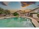 Backyard pool with hot tub, covered patio, and desert landscaping at 3440 E Topeka Dr, Phoenix, AZ 85050