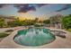 Private backyard pool with rock waterfall and lush desert landscaping at 3440 E Topeka Dr, Phoenix, AZ 85050