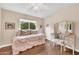 Bright bedroom features hardwood floors, natural light, and a daybed with a trundle and white wooden desk at 3440 E Topeka Dr, Phoenix, AZ 85050