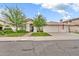 Charming single-story home featuring a well-manicured lawn and an attached three-car garage at 3440 E Topeka Dr, Phoenix, AZ 85050