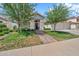 Charming home with a well-manicured lawn, mature trees, and a welcoming front entrance at 3440 E Topeka Dr, Phoenix, AZ 85050