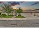 Charming home featuring a three-car garage and manicured front lawn at 3440 E Topeka Dr, Phoenix, AZ 85050