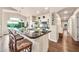 Kitchen with large island, granite countertops, seating, stainless appliances, and backyard views at 3440 E Topeka Dr, Phoenix, AZ 85050
