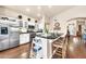 Kitchen with large island, granite countertops, seating, stainless appliances, and white cabinets at 3440 E Topeka Dr, Phoenix, AZ 85050