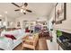 Open-concept living room with hardwood floors, fireplace, comfortable seating, and built-in shelving at 3440 E Topeka Dr, Phoenix, AZ 85050
