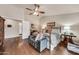 Charming main bedroom suite boasts a ceiling fan, wood floors, and a full ensuite bathroom with white doors at 3440 E Topeka Dr, Phoenix, AZ 85050