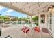 Outdoor patio with string lights overlooks pool and waterfall feature, perfect for outdoor entertaining at 3440 E Topeka Dr, Phoenix, AZ 85050