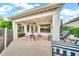 Inviting patio with stylish outdoor furniture, lush greenery, and atmospheric string lights for evening enjoyment at 3440 E Topeka Dr, Phoenix, AZ 85050