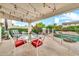 Outdoor patio with string lights overlooks pool and waterfall feature, perfect for outdoor entertaining at 3440 E Topeka Dr, Phoenix, AZ 85050