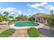 Backyard pool with lush landscaping, fenced-in pool area, and covered patio at 3440 E Topeka Dr, Phoenix, AZ 85050