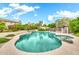 Inviting pool with baja step, spa, and rock waterfall surrounded by lush landscaping at 3440 E Topeka Dr, Phoenix, AZ 85050