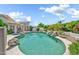 Backyard featuring a pool, spa, rock waterfall, and lush landscaping at 3440 E Topeka Dr, Phoenix, AZ 85050