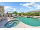 Backyard pool and spa area, featuring rock features and lush tropical landscaping at 3440 E Topeka Dr, Phoenix, AZ 85050