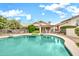 Beautiful backyard pool and spa with safety fence, patio, and lush landscaping at 3440 E Topeka Dr, Phoenix, AZ 85050