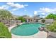 A lushly landscaped backyard features a swimming pool, spa, and fenced-in patio at 3440 E Topeka Dr, Phoenix, AZ 85050