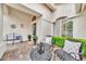 Comfortable front porch area, featuring a decorative door, outdoor seating, and manicured plants at 3440 E Topeka Dr, Phoenix, AZ 85050