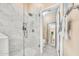Modern bathroom shower featuring marble and glass with built in shelving for toiletries at 3440 E Topeka Dr, Phoenix, AZ 85050