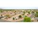 Captivating aerial image shows a home, swimming pool, and neighborhood amidst desert landscape at 35656 N Shorthorn Trl, San Tan Valley, AZ 85143