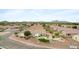 View of a desert community featuring a home with a private backyard pool and a rock waterfall feature at 35656 N Shorthorn Trl, San Tan Valley, AZ 85143