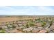 This aerial shows a desert community with homes nestled along a highway, accented by desert flora and a clear sky at 35656 N Shorthorn Trl, San Tan Valley, AZ 85143