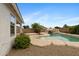 Wide backyard showcasing rock waterfall pool and landscaping at 35656 N Shorthorn Trl, San Tan Valley, AZ 85143