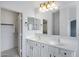 Bathroom featuring double sinks, a large mirror and a view of a walk-in closet at 35656 N Shorthorn Trl, San Tan Valley, AZ 85143