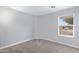 Simple bedroom featuring a neutral carpet, window and view of the outdoors at 35656 N Shorthorn Trl, San Tan Valley, AZ 85143