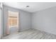 Bedroom featuring tile flooring, large window with light-filtering blinds and patio door at 35656 N Shorthorn Trl, San Tan Valley, AZ 85143