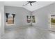 Bright bedroom with multiple windows, neutral paint and herringbone-patterned flooring at 35656 N Shorthorn Trl, San Tan Valley, AZ 85143