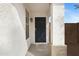 A quaint and welcoming entrance to the home, featuring a navy-blue door and neutral accents at 35656 N Shorthorn Trl, San Tan Valley, AZ 85143