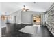 Spacious living area featuring vinyl floors, neutral walls, ceiling fan, and sliding glass doors to the backyard at 35656 N Shorthorn Trl, San Tan Valley, AZ 85143