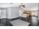 Open concept living area leads to the kitchen, featuring dark vinyl floors and neutral-colored walls at 35656 N Shorthorn Trl, San Tan Valley, AZ 85143