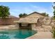 Close up of pool waterfall feature with rock overhang at 35656 N Shorthorn Trl, San Tan Valley, AZ 85143