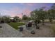 Expansive backyard featuring a patio, lush trees, and a charming pergola for outdoor relaxation at 35773 N Loemann Dr, San Tan Valley, AZ 85143