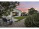 Enjoy a backyard oasis with a covered patio, pergola, and a neatly manicured artificial grass area at 35773 N Loemann Dr, San Tan Valley, AZ 85143