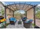 Backyard patio seating area beneath a pergola, perfect for enjoying warm summer afternoons at 35773 N Loemann Dr, San Tan Valley, AZ 85143