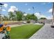 Spacious backyard with artificial turf and paver patio seating area with lounging chairs and open space at 35773 N Loemann Dr, San Tan Valley, AZ 85143