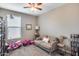 Bright bedroom with neutral walls, a cozy couch, and playful scooters at 35773 N Loemann Dr, San Tan Valley, AZ 85143