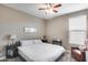 Comfortable bedroom with a ceiling fan, carpeted floors, and natural light at 35773 N Loemann Dr, San Tan Valley, AZ 85143