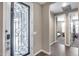 Front door featuring decorative glass details, leading into a tiled entryway at 35773 N Loemann Dr, San Tan Valley, AZ 85143