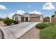 Charming single-story home with a manicured front yard and an extended driveway leading to the garage at 35773 N Loemann Dr, San Tan Valley, AZ 85143