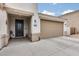 Close-up of the front door and three-car garage, showing the home's address at 35773 N Loemann Dr, San Tan Valley, AZ 85143