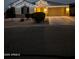 Festive single-Gathering home with a two-car garage and desert landscaping adorned with colorful Christmas lights at 35773 N Loemann Dr, San Tan Valley, AZ 85143