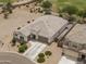 Aerial view of the home's front exterior, featuring a well-manicured lawn, driveway, and garage at 35773 N Loemann Dr, San Tan Valley, AZ 85143