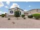 Charming front yard with gravel landscaping, mature bushes, and a view of the single story property at 35773 N Loemann Dr, San Tan Valley, AZ 85143