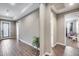 Inviting hallway with wood floors and a view into the playroom at 35773 N Loemann Dr, San Tan Valley, AZ 85143