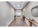 Inviting hallway with wood-look flooring and stylish console tables at 35773 N Loemann Dr, San Tan Valley, AZ 85143